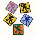 Five 2-inch square Prankster embroidered iron-on patches in pink, yellow, blue, green, and orange