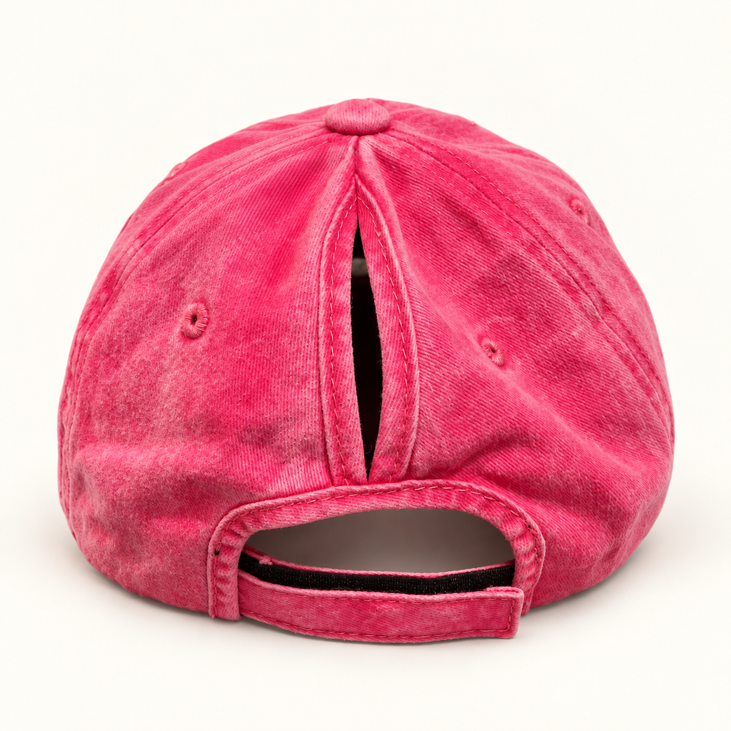 Back view of the hot pink ponytail hat with the vertical hair opening and adjustable strap closed.