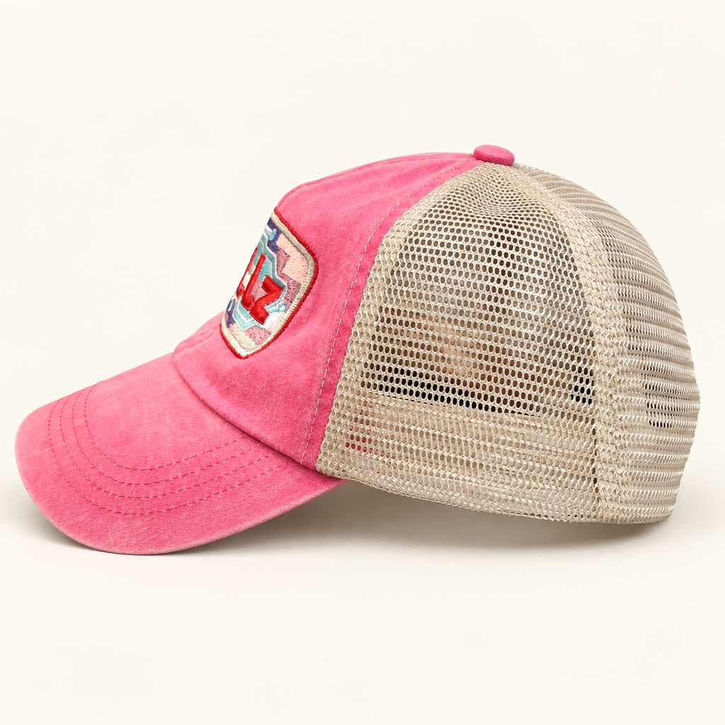 Side profile of the hot pink baseball cap emphasizing its breathable light tan mesh construction.