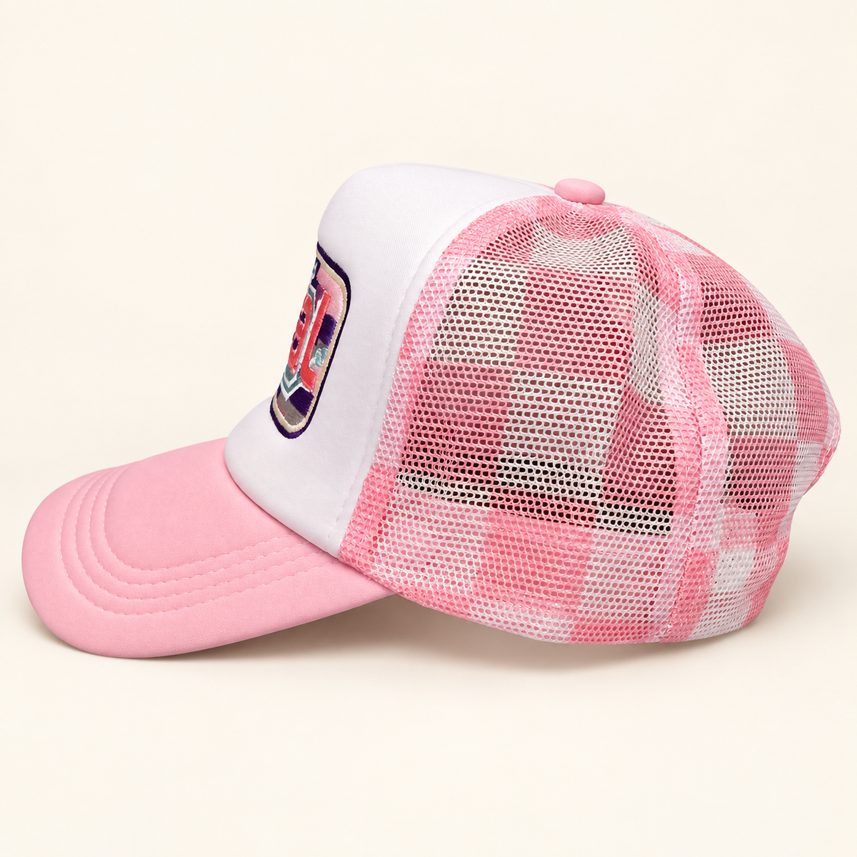 Side and rear view of the pink plaid FERAL trucker hat showing the checked mesh panels and pink brim.