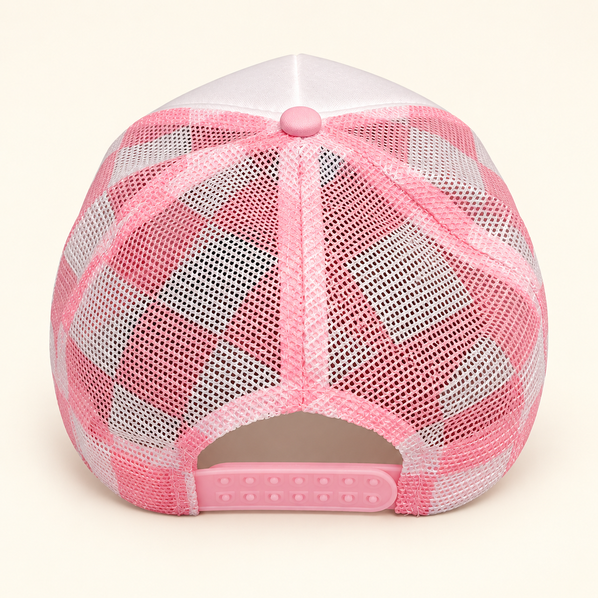 Rear view of the pink plaid FERAL trucker hat showing the checked mesh and adjustable pink snapback closure.