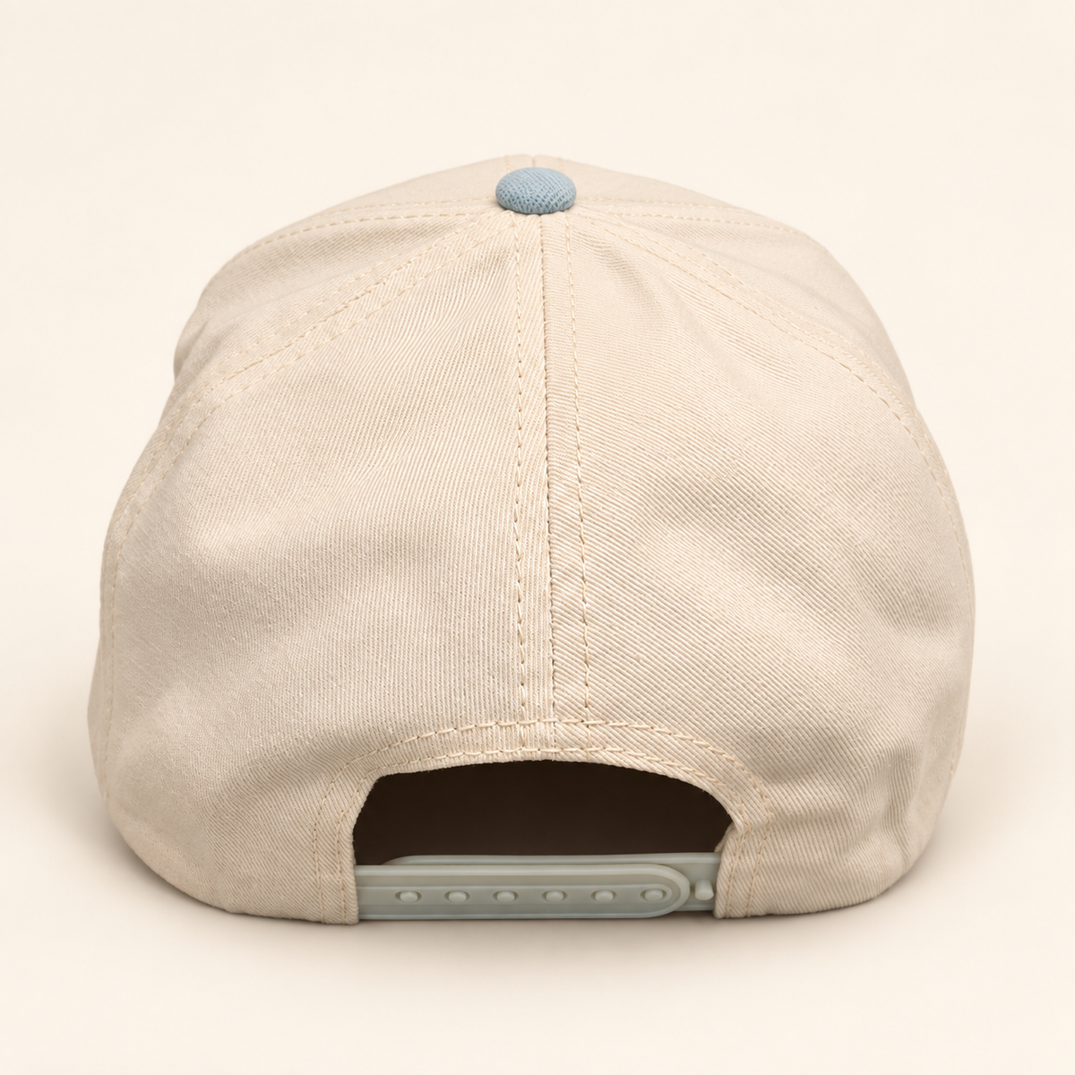 Rear view of the powder-blue FERAL hat showing the solid cream crown and adjustable snapback closure.